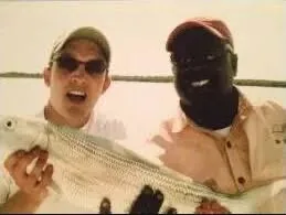 Smiling guest and guide presenting a bonefish