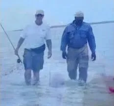 Two anglers wading on an Exuma sand flat